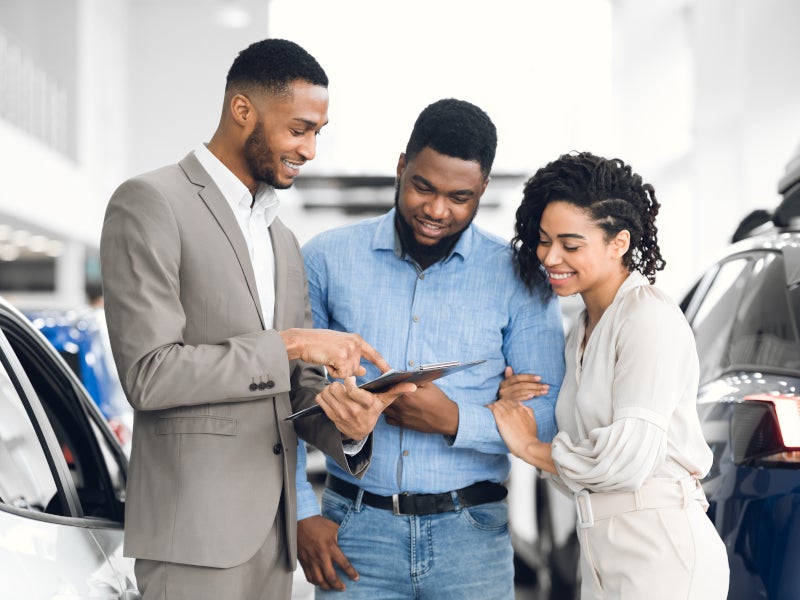 couple looking at a car